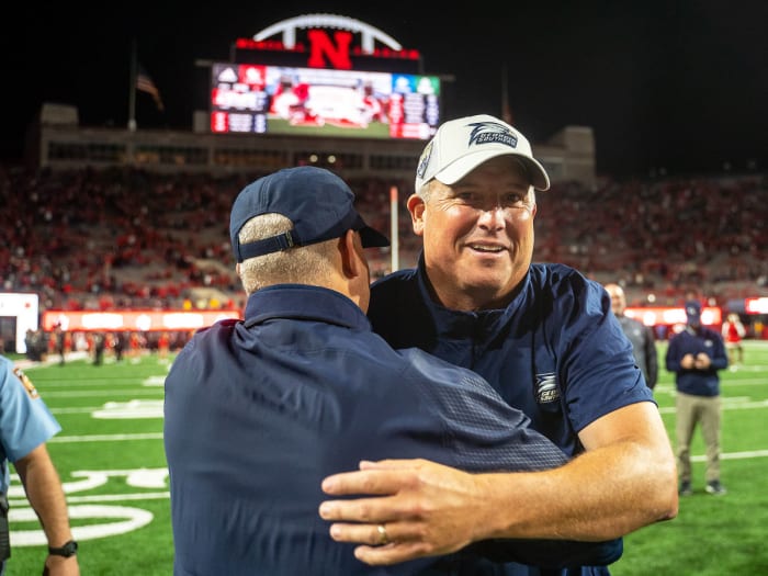 Clay Helton hugs an assistant after beating Nebraska